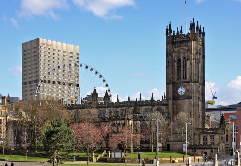 Manchester Cathedral med nyt i baggrunden
